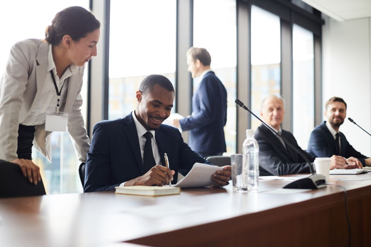 GettyImages-1073477832 A man in a suit and tie sitting at a table.